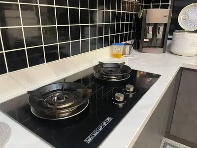 two pans sitting on a stove top in a kitchen at LSH33 Condo DUKE Sentul KL in Kuala Lumpur