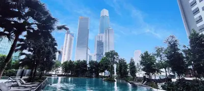 a swimming pool in a city with tall buildings at Agile Malaysia Apartment KL in Kuala Lumpur