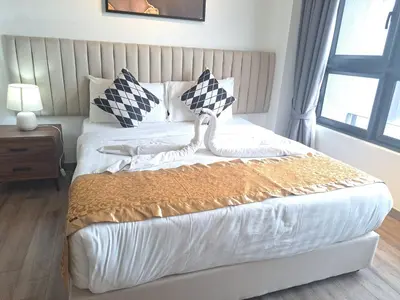 a bedroom with a bed with white sheets and a window at Agile Malaysia Apartment KL in Kuala Lumpur