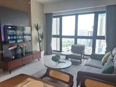 a living room with a couch and a large window at Agile Malaysia Apartment KL in Kuala Lumpur
