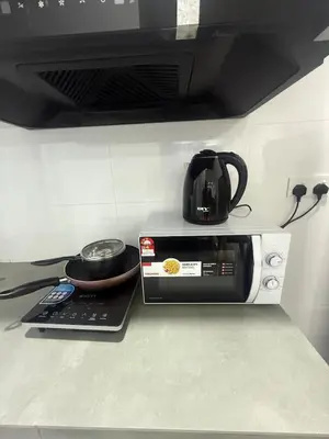a coffee pot sitting on top of a microwave at Cozy Kenwingston Setapak 3BR & 2BR 5-8 Pax l Parking & Netflix 3201 in Kuala Lumpur