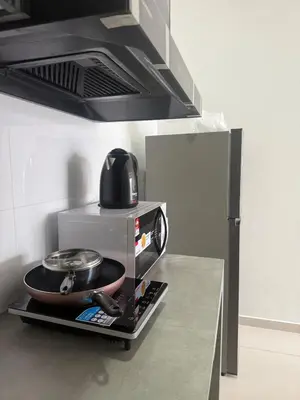 a microwave oven with a pan on top of it at Cozy Kenwingston Setapak 3BR & 2BR 5-8 Pax l Parking & Netflix 3201 in Kuala Lumpur