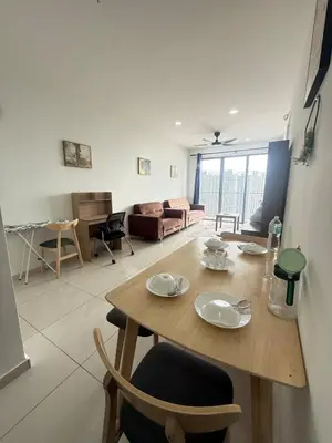 a dining room and living room with a table and chairs at Cozy Kenwingston Setapak 3BR & 2BR 5-8 Pax l Parking & Netflix 3201 in Kuala Lumpur