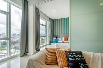 a living room with a couch and large windows at Platinum in Kuala Lumpur