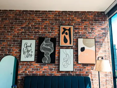 a brick wall with framed art on it at Skyline Homes by Myfly247 in Kuala Lumpur