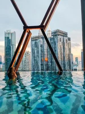 a infinity pool with a view of a city at Skyline Homes by Myfly247 in Kuala Lumpur