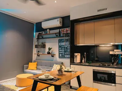 a kitchen and a living room with a table and a couch at Skyline Homes by Myfly247 in Kuala Lumpur