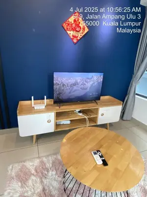 a living room with a tv and a table at NiceStay in Kuala Lumpur