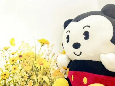 a stuffed panda bear sitting next to a field of flowers at Setapak Central KL - Zetapark Summer Suites in Kuala Lumpur