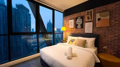 a bedroom with a bed with a teddy bear on it at Scarletz Suite KLCC by Light House 1 in Kuala Lumpur