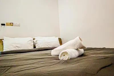 a bed with two pillows on top of it at Trion1 in Kuala Lumpur