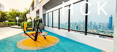 a chair on a balcony with a view of the city at Trion1 in Kuala Lumpur