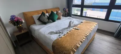 a large bed in a room with a large window at Agile Service Residence by TRX KLCC in Kuala Lumpur