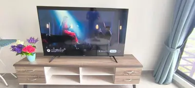 a flat screen tv sitting on a wooden entertainment center at Agile Service Residence by TRX KLCC in Kuala Lumpur
