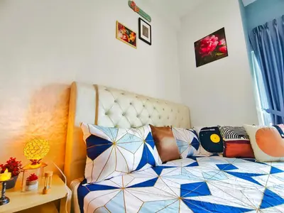 a bedroom with a bed with colorful pillows on it at Master Room, Razak City Residence in Kuala Lumpur