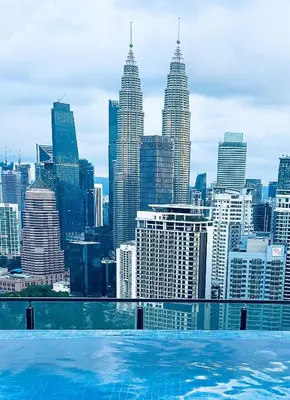 a swimming pool with a view of a city skyline at The Luxe & Colony KLCC By LuxeHub in Kuala Lumpur