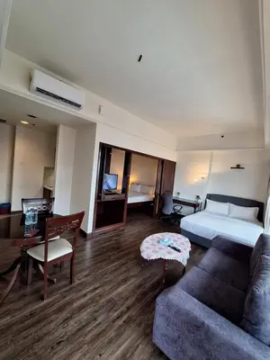 a hotel room with a bed and a couch at KL Times Square Hotel Service Suite in Kuala Lumpur