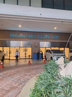 a car dealership with cars parked in a parking lot at KL Times Square Hotel Service Suite in Kuala Lumpur