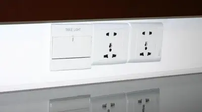 a white lightswitch on top of a white wall at Cardogan Hotel in Kuala Lumpur