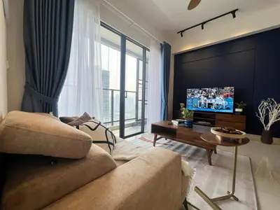 a living room with a couch and a flat screen tv at trion kl TRX klcc view in Kuala Lumpur