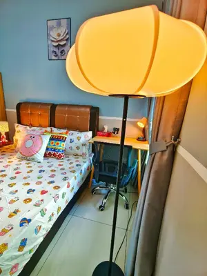 a bedroom with a bed and a desk with a lamp at Master Room at Razak City Residence in Kuala Lumpur