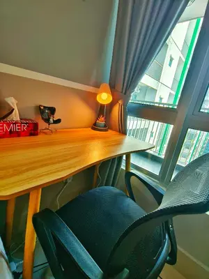 a desk with a lamp and a chair next to a window at Master Room at Razak City Residence in Kuala Lumpur