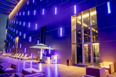a building with chairs and an umbrella in front of it at The Calma, Platinum Suites 2 BR in Kuala Lumpur
