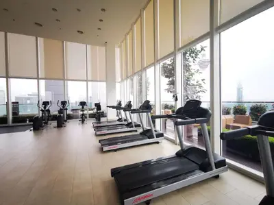 a gym with a row of treadmills and machines at The Calma, Platinum Suites 2 BR in Kuala Lumpur