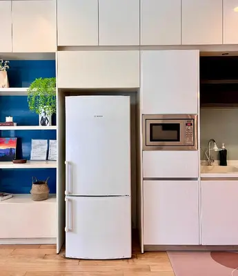 a white refrigerator in a kitchen with a microwave at The Calma, Platinum Suites 2 BR in Kuala Lumpur
