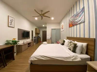 a bedroom with a large bed with a ceiling fan at Staybliss At Ceylonz Suites KLCC in Kuala Lumpur