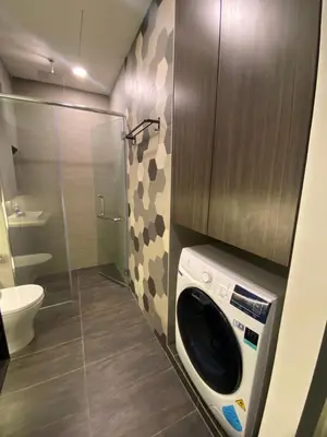 a washing machine in a bathroom with a toilet at Staybliss At Ceylonz Suites KLCC in Kuala Lumpur