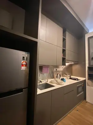 a kitchen with white cabinets and a sink at Staybliss At Ceylonz Suites KLCC in Kuala Lumpur