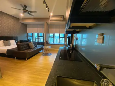 a bedroom with a bed and a couch in a room at Staybliss At Ceylonz Suites KLCC in Kuala Lumpur