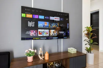 a tv hanging on a wall in a living room at Premium Stay Central KL Next to TRX Mall & IKEA in Kuala Lumpur