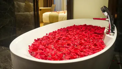 a bath tub filled with red valentines hearts at Imperial Residences KLCC - MK HOME in Kuala Lumpur