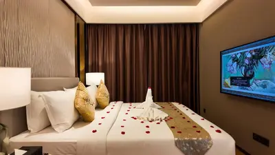 a hotel room with a large bed with flowers on it at Imperial Residences KLCC - MK HOME in Kuala Lumpur