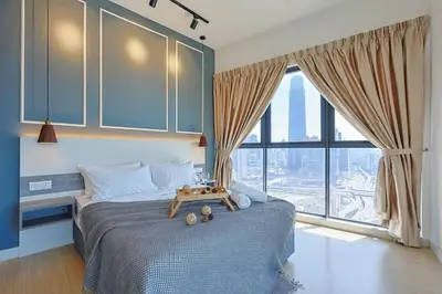 a bedroom with a bed and a large window at Luxurious TRX Corner Dual Balconies 2 Bedrooms in Kuala Lumpur