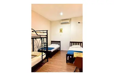 a room with two bunk beds and a staircase at The Explorers Guesthouse and Hostel in Kuala Lumpur