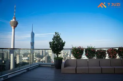a couch on a roof with a view of the city at SkyPool KLCC 2BR Platinum Suite D33F with Netflix in Kuala Lumpur