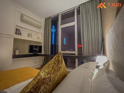 a bedroom with a bed and a window with a view at SkyPool KLCC 2BR Platinum Suite D33F with Netflix in Kuala Lumpur