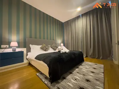 a bedroom with a bed with a teddy bear on it at Sky Pool KLCC 2BR Platinum Suite C33 with Netflix in Kuala Lumpur