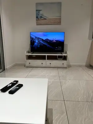 a flat screen tv sitting on a white entertainment center at Comfort Suites At Quill Residence in Kuala Lumpur