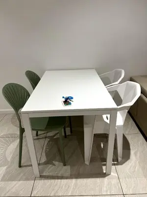 a white table and chairs in a room at Comfort Suites At Quill Residence in Kuala Lumpur