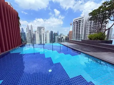 a swimming pool on the roof of a building with a city at Majestic Premium suites KLCC in Kuala Lumpur