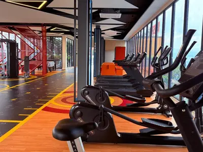 a gym with rows of treadmills and ellipticals at Majestic Luxury Suites KLCC By Home stay in Kuala Lumpur