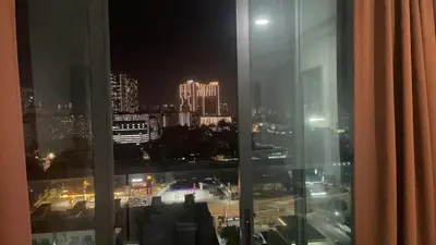 a view of a city at night from a window at \u670d\u52a1\u5f0f\u516c\u5bd3 in Kuala Lumpur