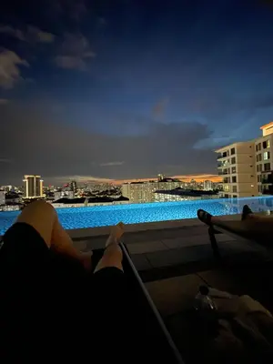 a person laying on a balcony looking out at the city at \u670d\u52a1\u5f0f\u516c\u5bd3 in Kuala Lumpur