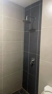 a shower with a glass door with a toilet at \u670d\u52a1\u5f0f\u516c\u5bd3 in Kuala Lumpur