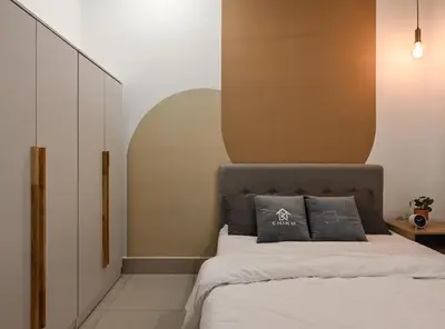 a bedroom with a bed with two pillows on it at Jln Razak Mansion, in Kuala Lumpur