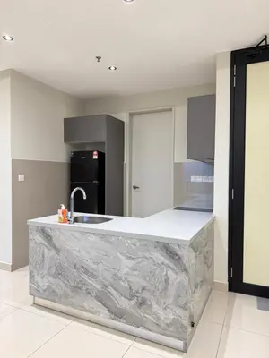 a kitchen with a marble counter with a sink at trion Klcc 2 bedroom apartment in Kuala Lumpur